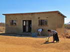 Shale is sweeping her front yard in preparation for the dedication