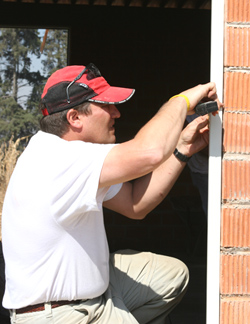 Man kneeling while working on doorway